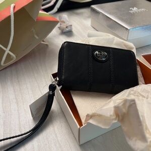 black leather coach wristlet with tags on and original packaging (birthday gift)
